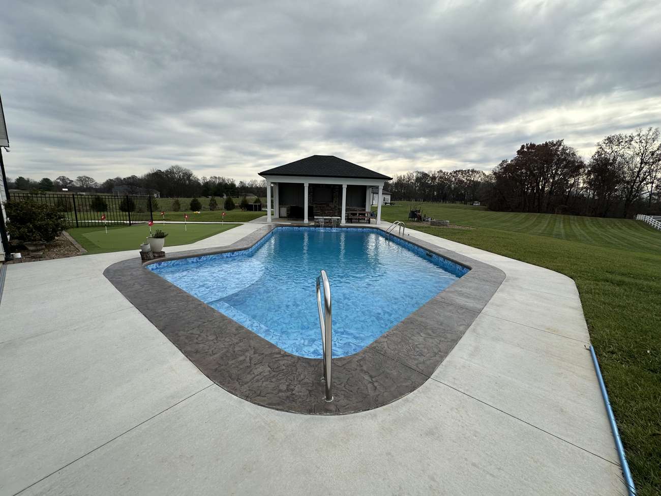 Pool with a covered pavilion in the background